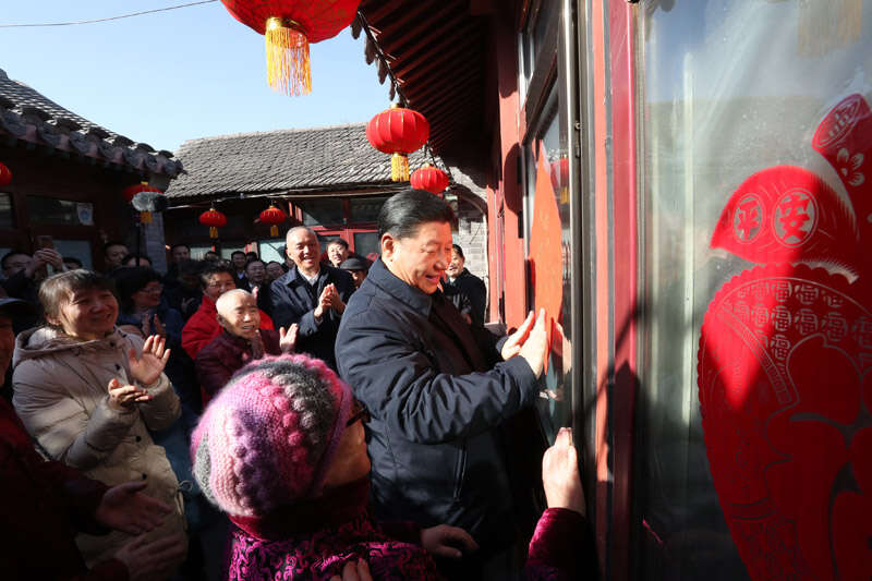2019年2月1日上午，習(xí)近平在北京前門東區(qū)草廠四條胡同32號(hào)院，高興地拿起一幅“福”字，親自貼到門上，給這里的老街坊們拜年。新華社記者 鞠鵬 攝